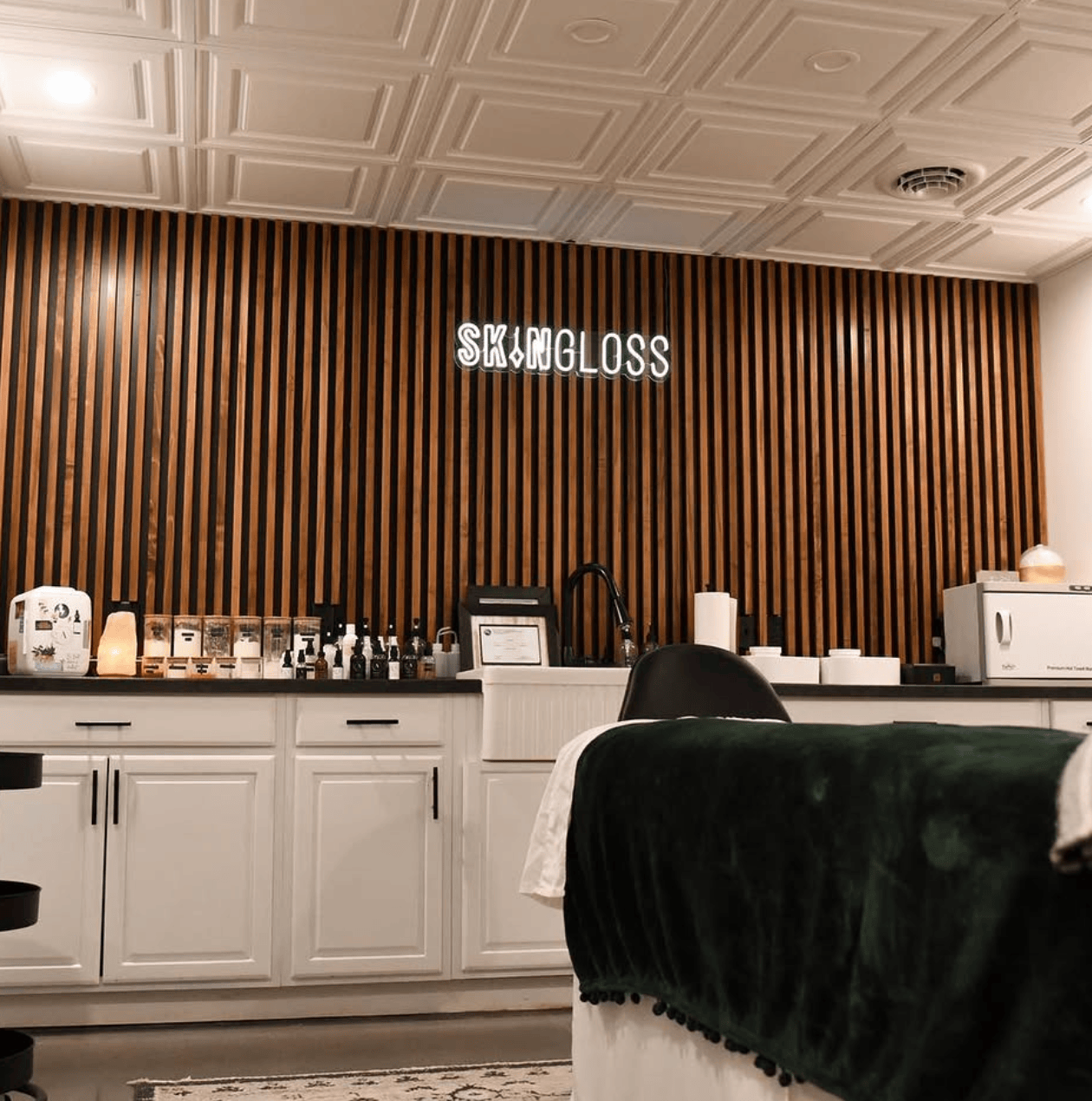 Skingloss treatment room with neon sign