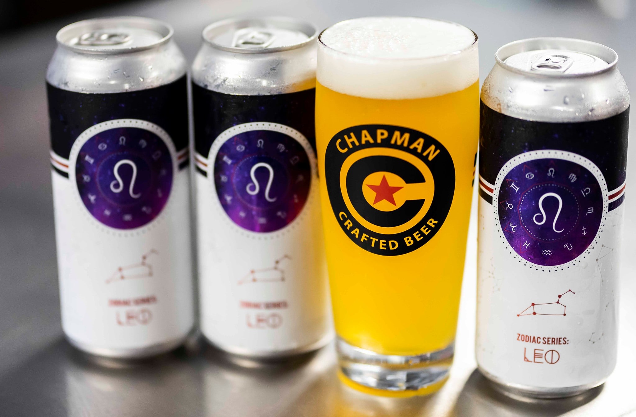 Zodiac Series Leo cans arranged on a bar top